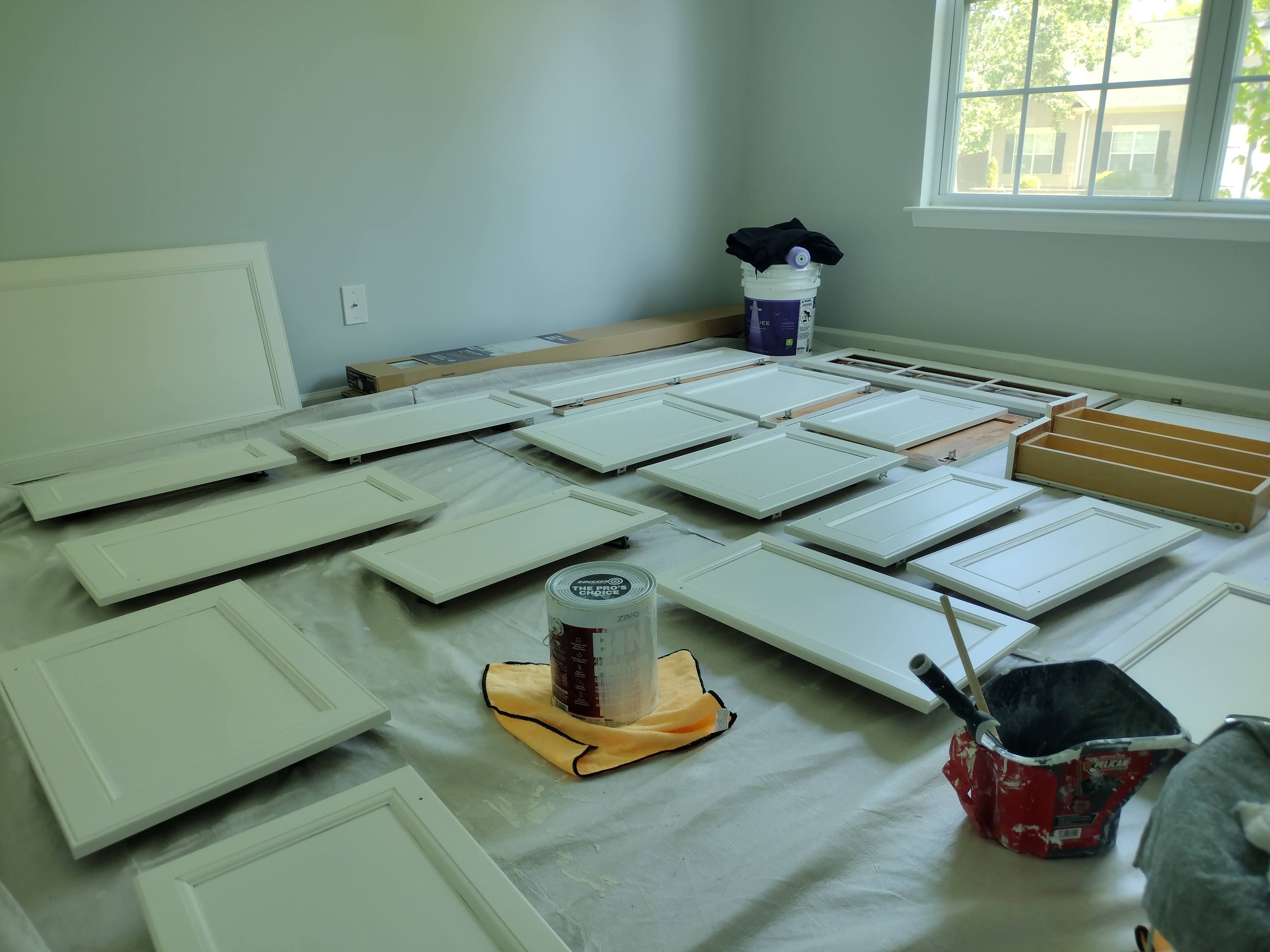 Cabinet doors mid-refinish — first color coat drying